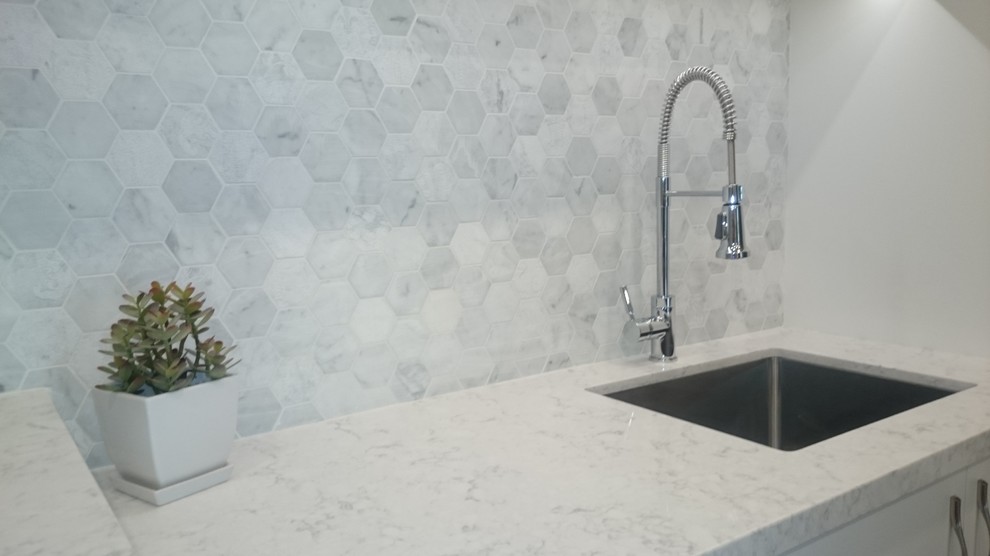 Example of a mid-sized transitional single-wall brown floor and dark wood floor home design design in Toronto with an undermount sink, flat-panel cabinets, white cabinets, a side-by-side washer/dryer, quartzite countertops and gray walls