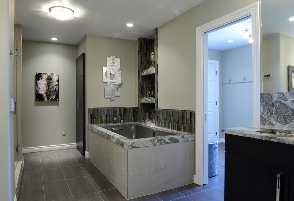 Photo of an expansive eclectic master bathroom in Other with an undermount sink, flat-panel cabinets, dark wood cabinets, engineered quartz benchtops, a corner tub, an alcove shower, a two-piece toilet, gray tile, porcelain tile, beige walls and porcelain floors.