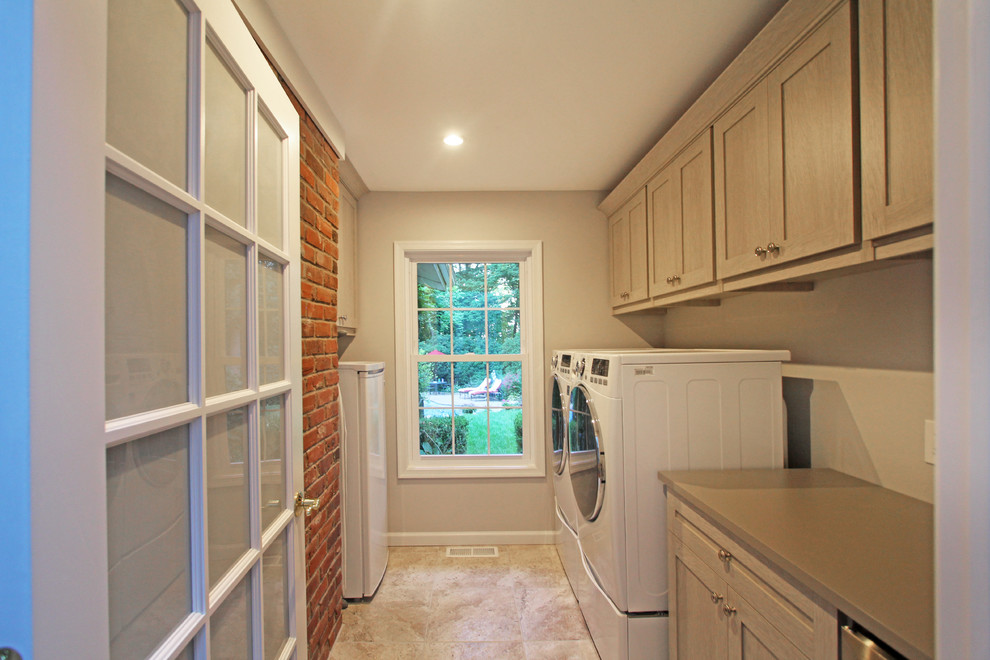 Small contemporary galley utility room in Philadelphia with shaker cabinets, beige cabinets, quartz benchtops, beige walls, porcelain floors and a side-by-side washer and dryer.