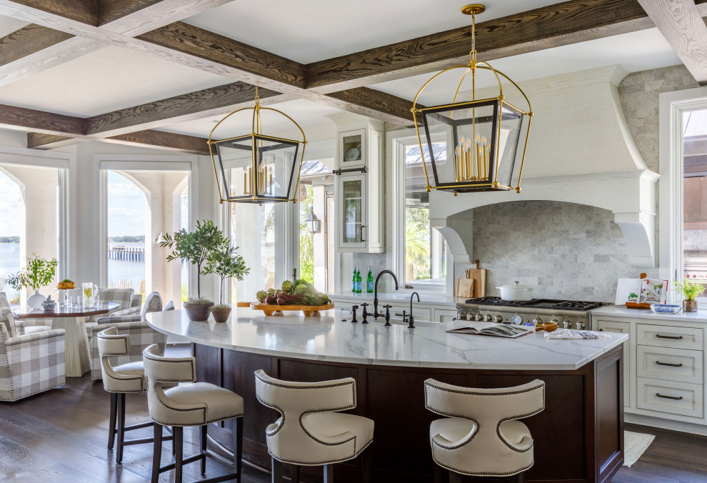Kitchen - large transitional l-shaped dark wood floor, brown floor and exposed beam kitchen idea in Jacksonville with a double-bowl sink, beaded inset cabinets, white cabinets, quartz countertops, beige backsplash, porcelain backsplash, paneled appliances, an island and white countertops