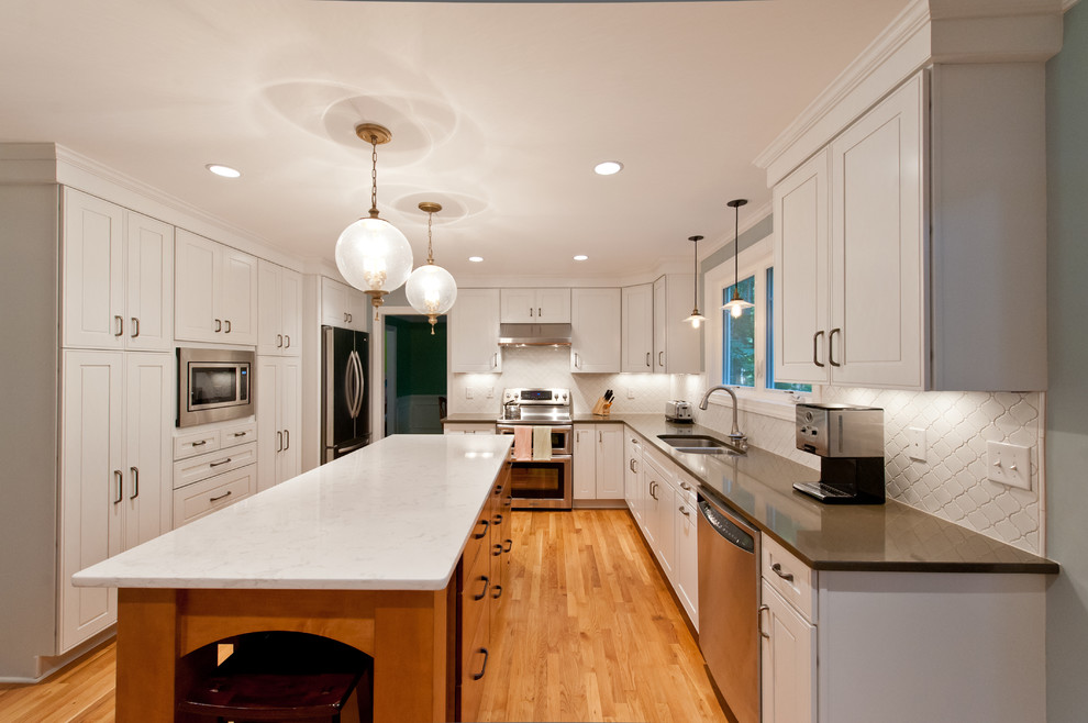Example of a transitional medium tone wood floor kitchen design in Richmond with a double-bowl sink, white backsplash, mosaic tile backsplash, stainless steel appliances, an island and quartzite countertops