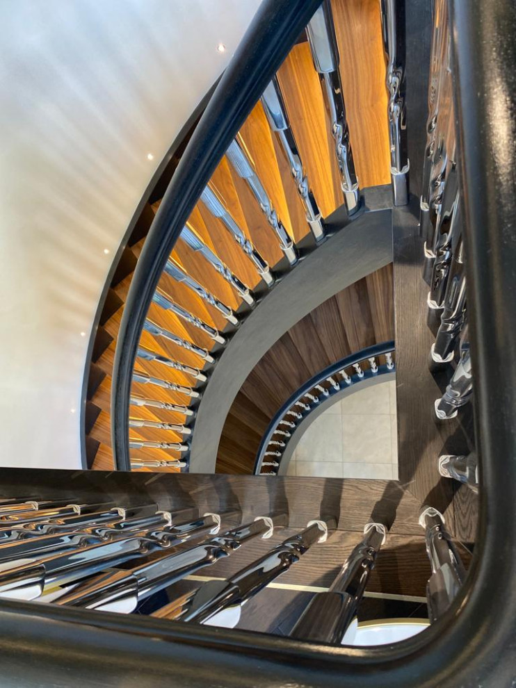 This is an example of an expansive modern wood spiral metal railing staircase spindle in Kent.