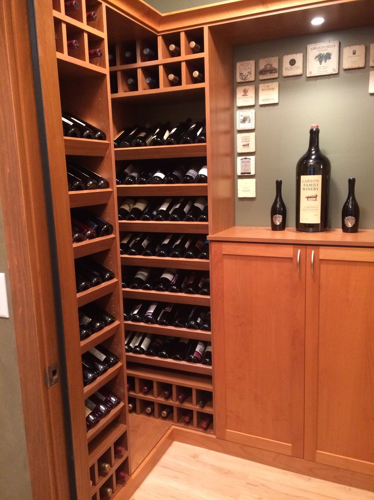 Inspiration for a small transitional wine cellar in Salt Lake City with laminate floors and display racks.