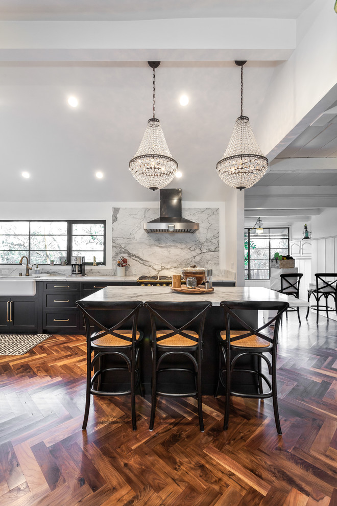 Design ideas for a mid-sized contemporary l-shaped eat-in kitchen in Los Angeles with an undermount sink, shaker cabinets, black cabinets, grey splashback, with island, brown floor, grey benchtop, marble benchtops, marble splashback, coloured appliances and linoleum floors.