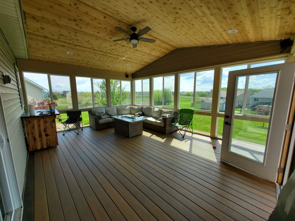Deck - large backyard second story metal railing deck idea with a roof extension