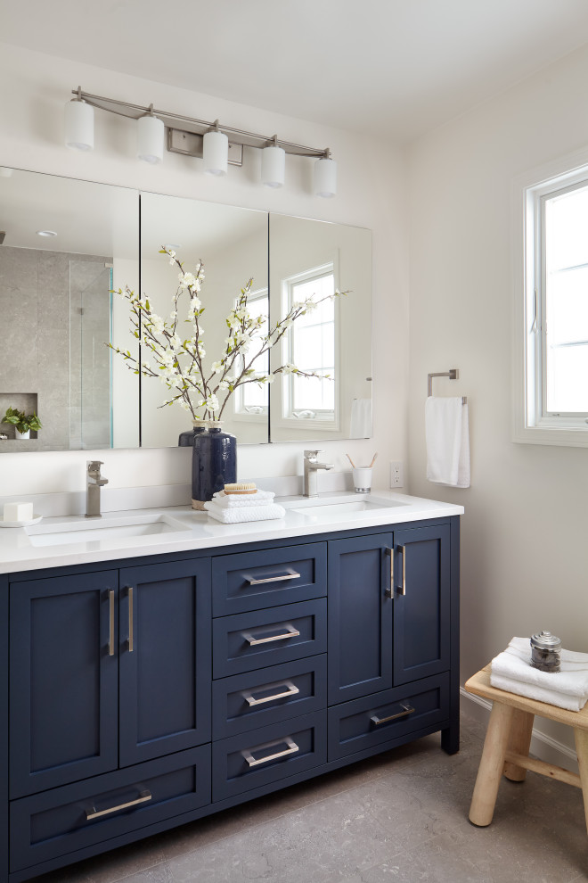 Mid-sized transitional master bathroom in San Francisco with shaker cabinets, blue cabinets, white walls, an undermount sink, grey floor, white benchtops, a double vanity, porcelain floors, quartzite benchtops, a freestanding vanity, a corner shower, gray tile, porcelain tile, a hinged shower door and a shower seat.