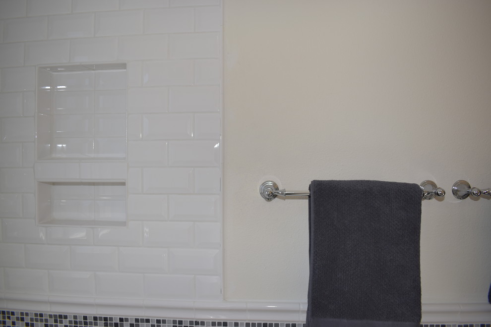 This is an example of a small contemporary kids bathroom in Other with white tile, subway tile, white walls and grey floor.