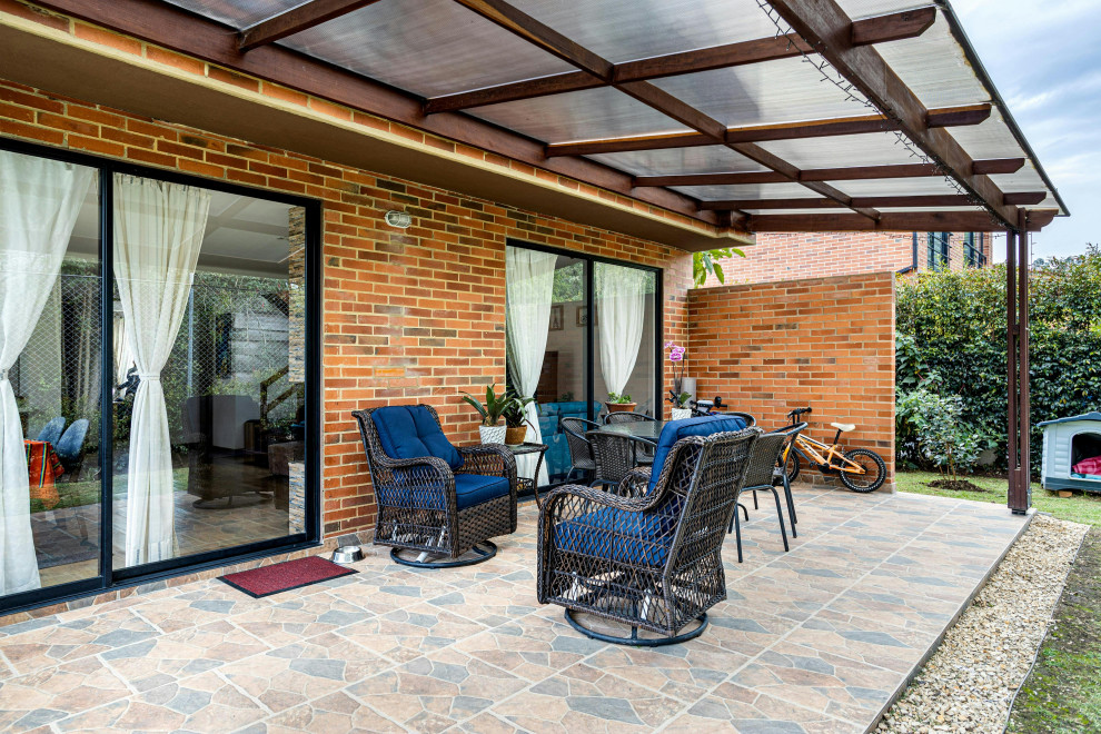 covered stone patio with double sliding doors