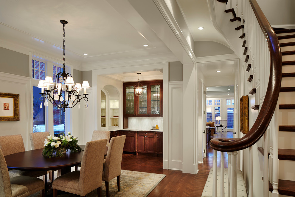 Large traditional dining room in Chicago with beige walls and dark hardwood floors.