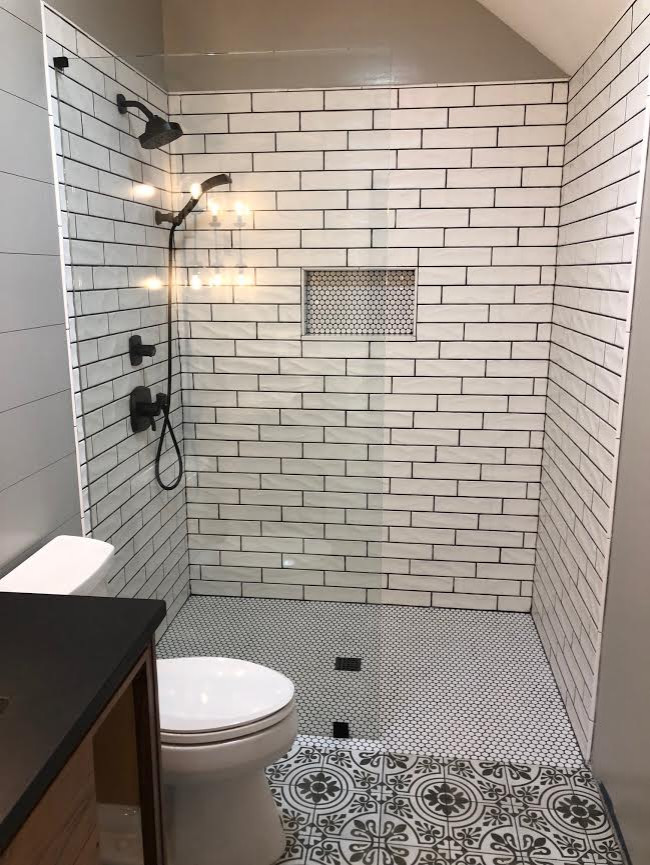 Photo of a mid-sized country 3/4 bathroom in Atlanta with a curbless shower, white tile, subway tile, brown walls, cement tiles, multi-coloured floor, an open shower and black benchtops.