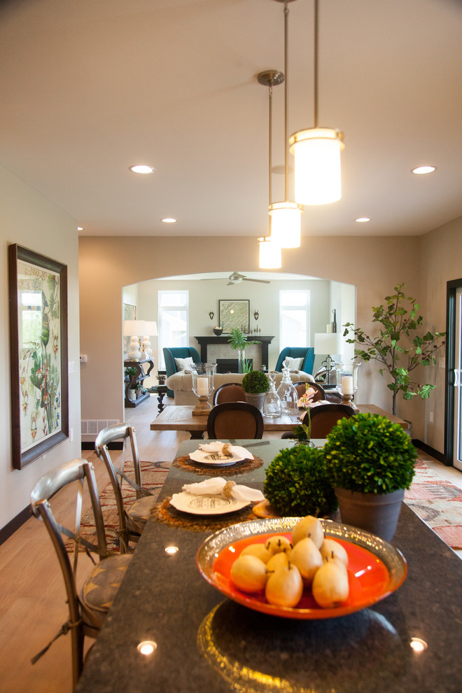 Mid-sized transitional open plan dining in Cedar Rapids with beige walls, light hardwood floors and brown floor.