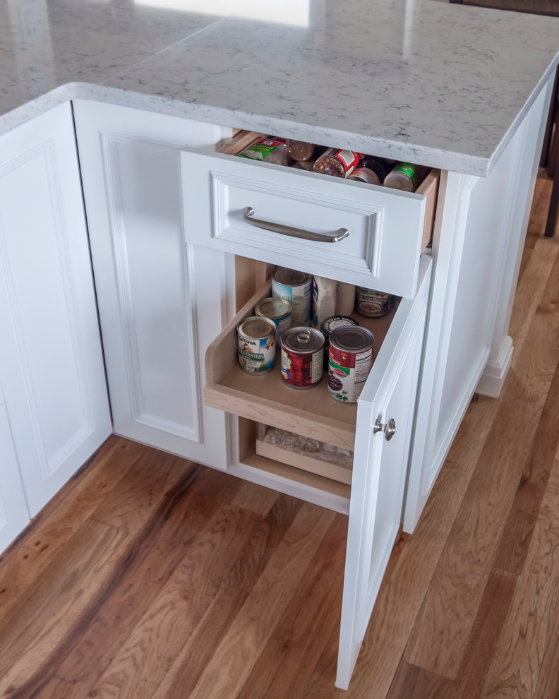 Eat-in kitchen - mid-sized transitional medium tone wood floor eat-in kitchen idea in Denver with a single-bowl sink, flat-panel cabinets, yellow cabinets, quartz countertops, blue backsplash, glass tile backsplash, white appliances and an island