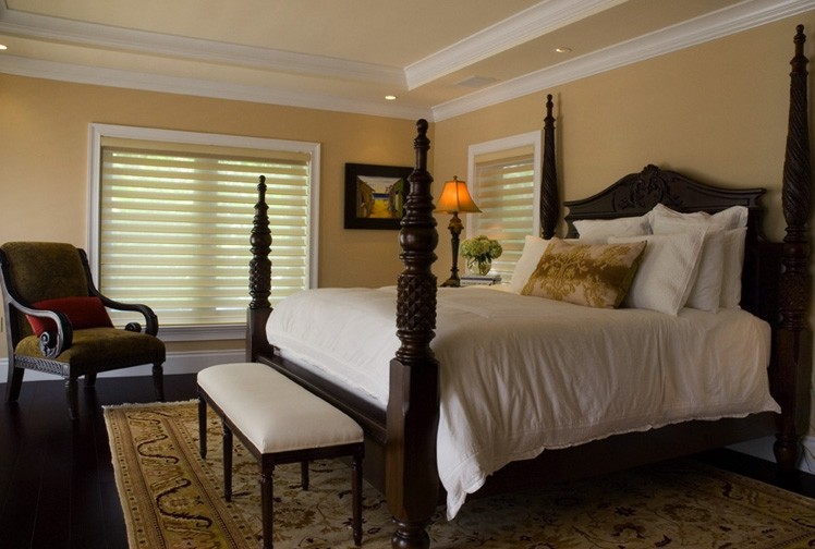 Large transitional master bedroom in Miami with beige walls and dark hardwood floors.