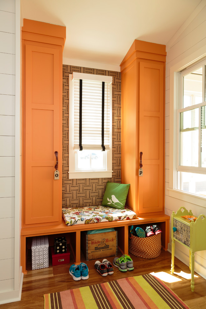 Design ideas for a mid-sized country mudroom in Little Rock with multi-coloured walls, medium hardwood floors and brown floor.