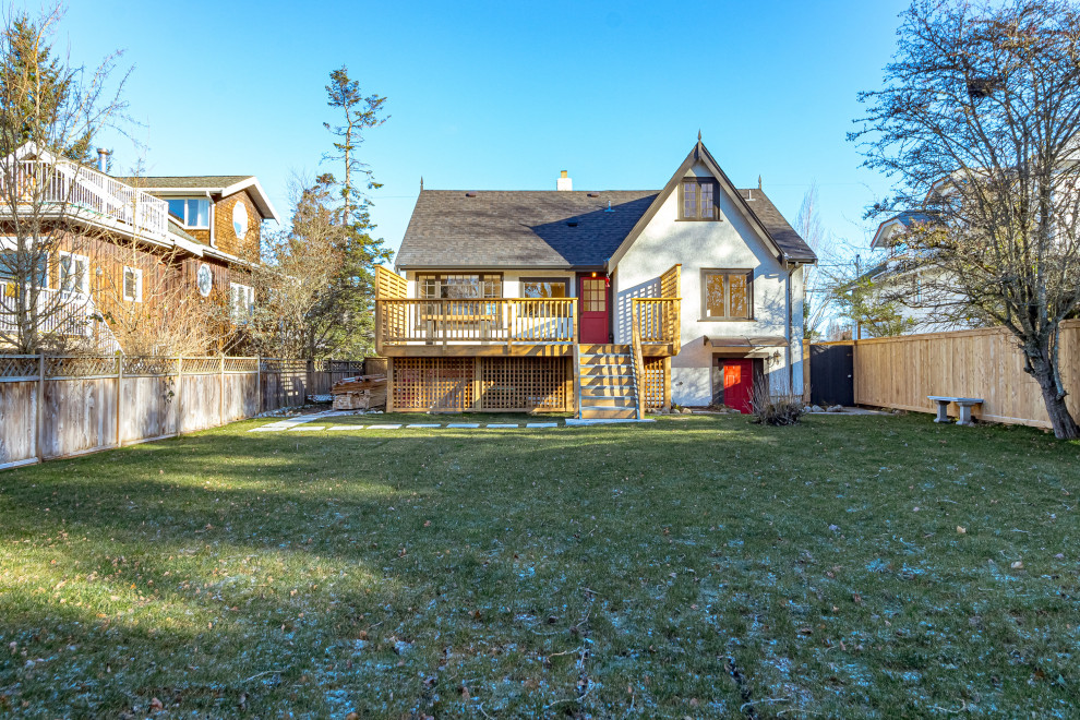 Deck - mid-sized transitional backyard second story privacy and wood railing deck idea