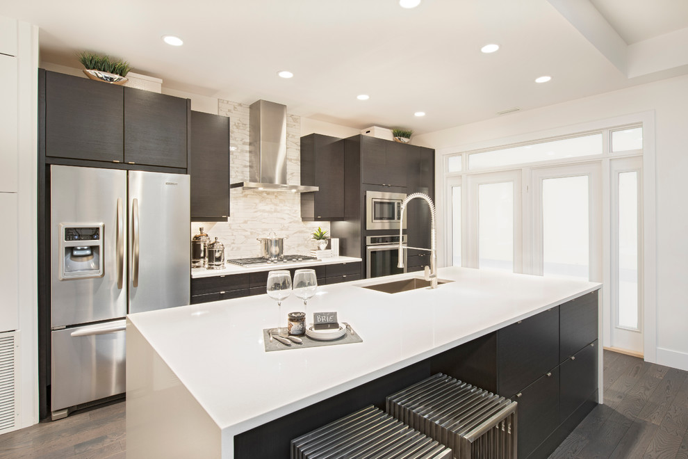 Design ideas for a contemporary eat-in kitchen in Calgary with an undermount sink, flat-panel cabinets, solid surface benchtops and stainless steel appliances.