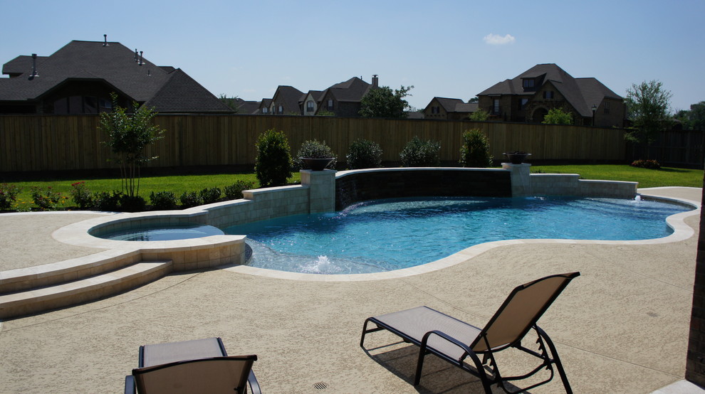 Design ideas for a mid-sized modern backyard custom-shaped pool in Houston with a hot tub and concrete slab.