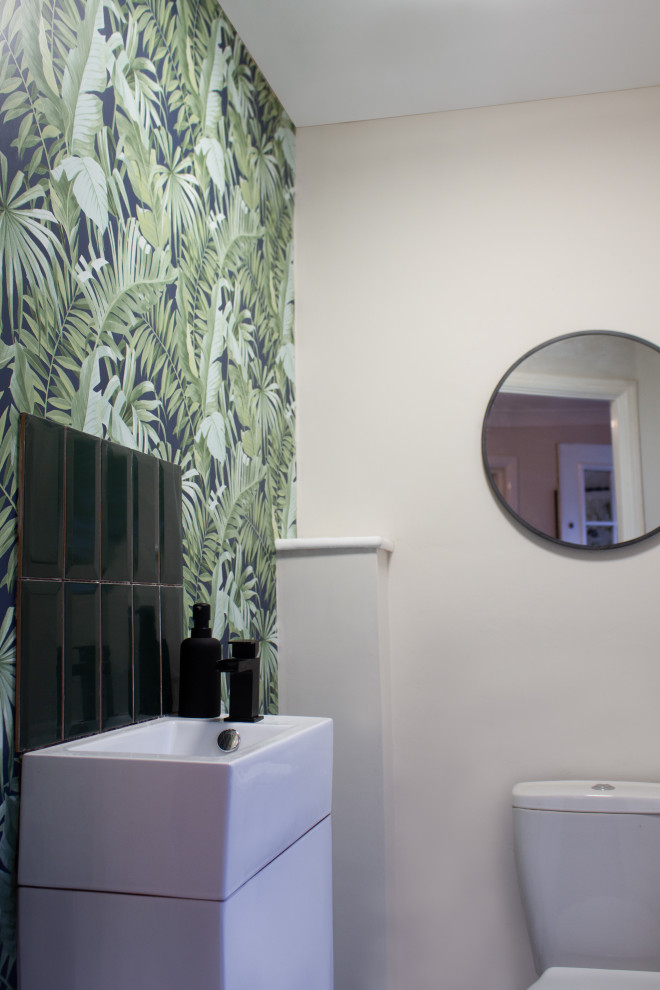 Small contemporary cloakroom in Gloucestershire with flat-panel cabinets, ceramic tiles, beige walls, vinyl flooring, beige floors, white cabinets, green tiles, a feature wall, a built in vanity unit and wallpapered walls.