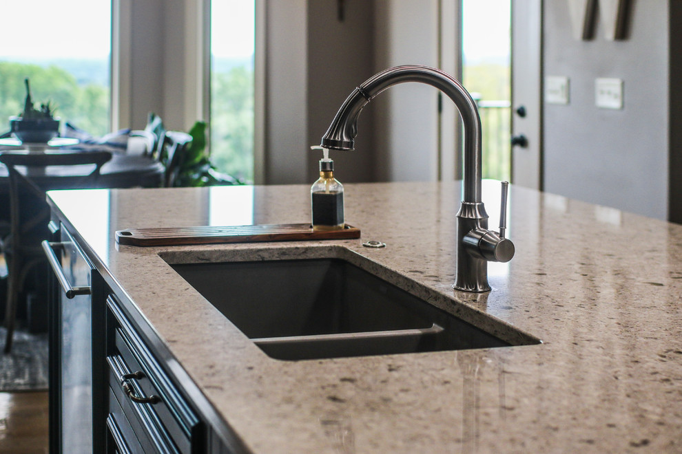 Inspiration for a large rustic single-wall medium tone wood floor and brown floor eat-in kitchen remodel with an undermount sink, raised-panel cabinets, gray cabinets, multicolored backsplash, stone tile backsplash, stainless steel appliances, an island, beige countertops and quartz countertops