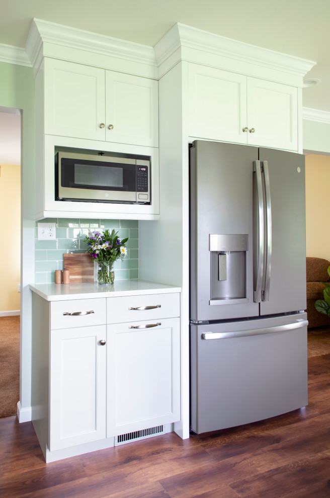 Transitional vinyl floor kitchen photo with an undermount sink, shaker cabinets, white cabinets, quartz countertops, green backsplash, glass tile backsplash, stainless steel appliances, no island and white countertops
