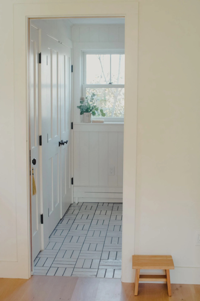 Photo of a country entrance in Other with brick flooring and white floors.