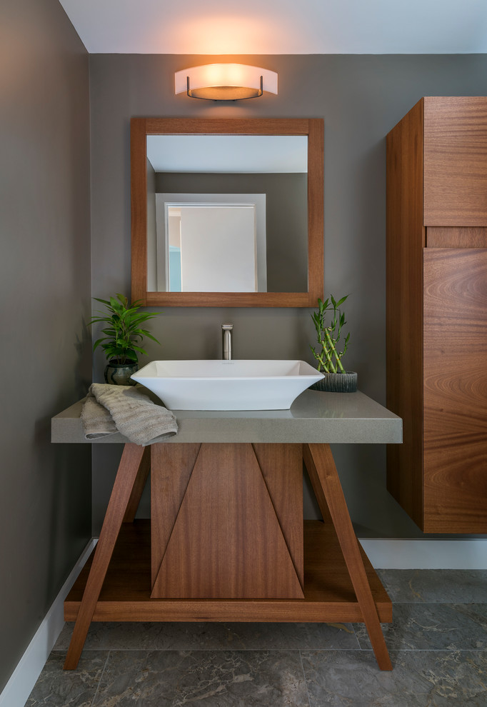 Design ideas for a small asian powder room in Boston with flat-panel cabinets, dark wood cabinets, a one-piece toilet, grey walls, slate floors, a vessel sink, limestone benchtops, grey floor and grey benchtops.