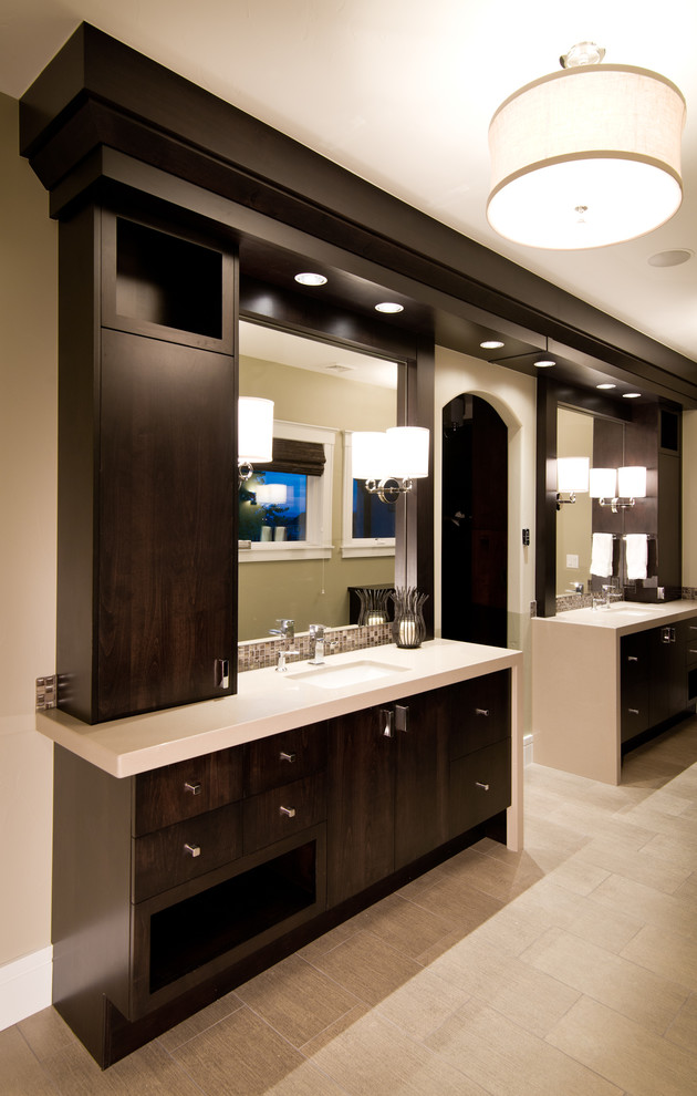 This is an example of a large modern master bathroom in Denver with flat-panel cabinets, dark wood cabinets, beige walls, porcelain floors, an undermount sink and beige floor.