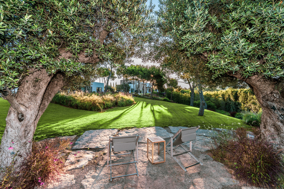 Expansive mediterranean garden in Other with with privacy feature.