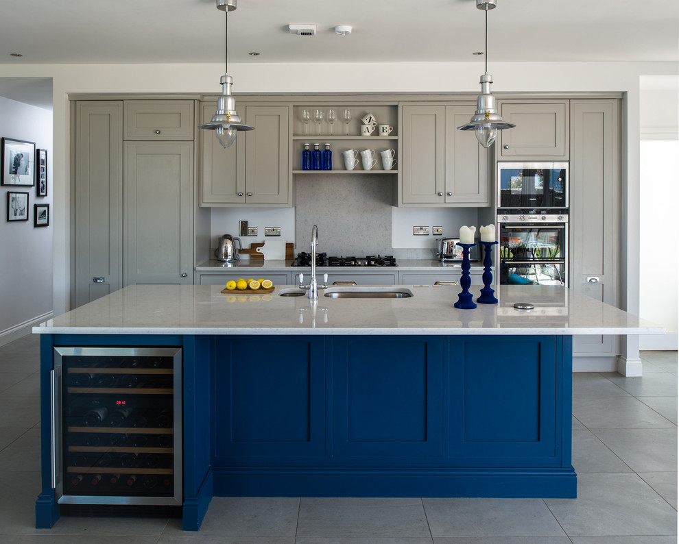 Design ideas for a large transitional galley open plan kitchen in Dublin with an integrated sink, recessed-panel cabinets, grey cabinets, quartz benchtops, grey splashback, porcelain floors and with island.