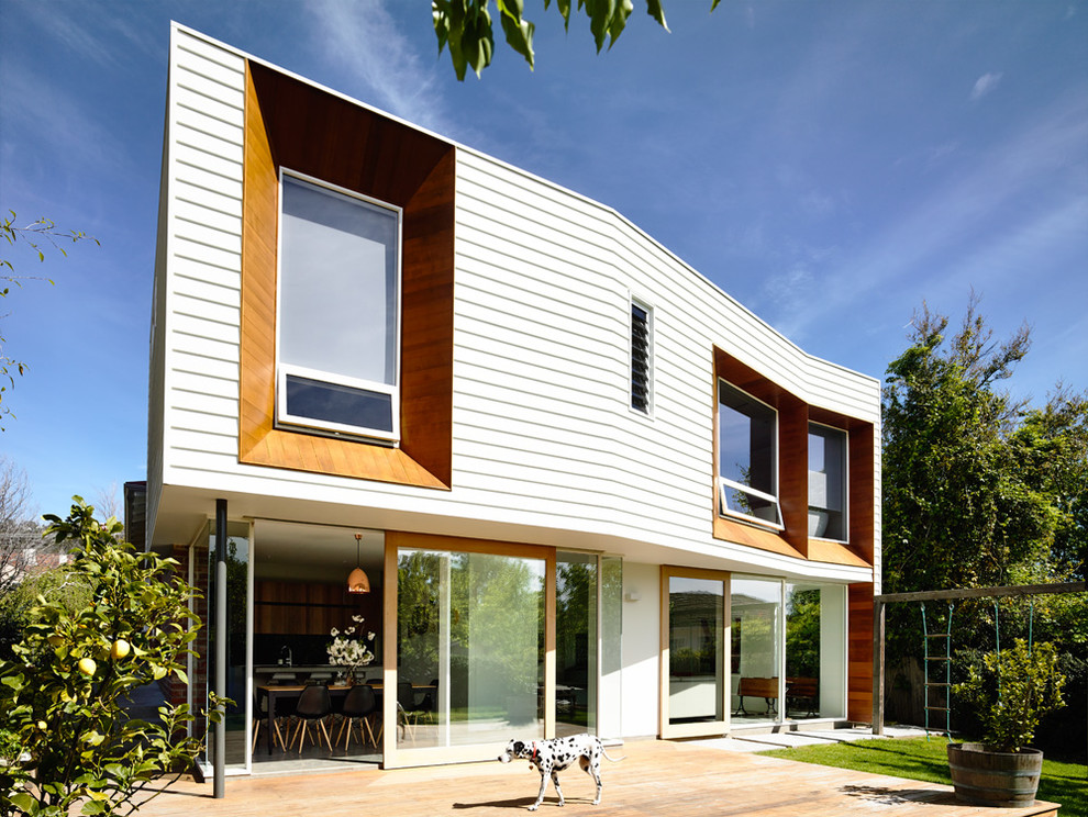 Photo of a contemporary two-storey white exterior in Hobart with wood siding.