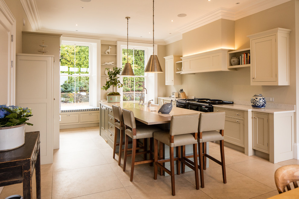 Photo of a transitional single-wall eat-in kitchen in London with shaker cabinets, beige cabinets, glass sheet splashback, black appliances and with island.