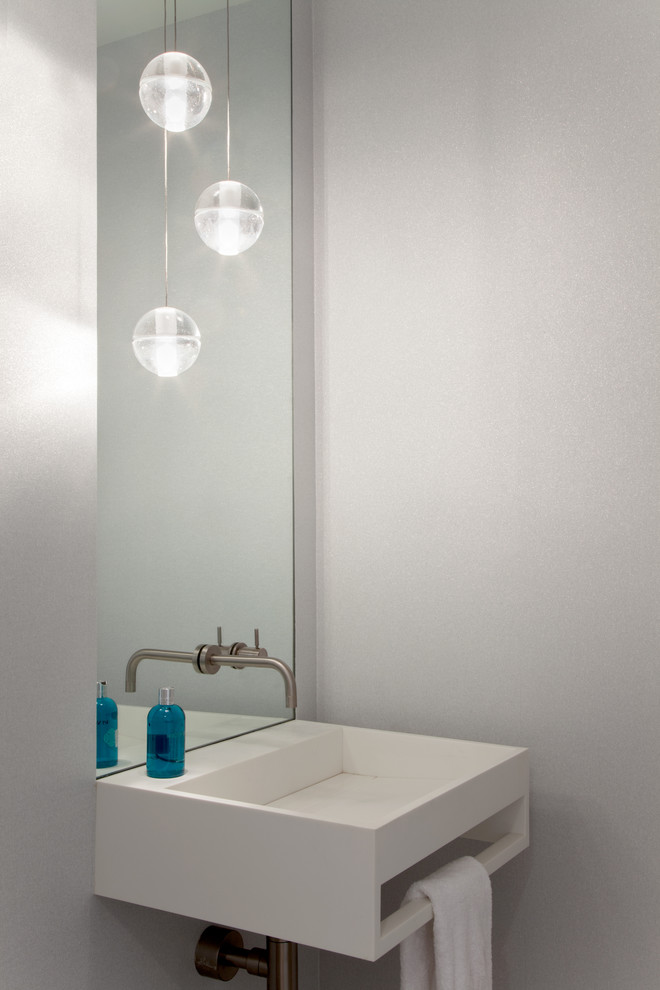 Photo of a modern powder room in New York with a wall-mount sink.