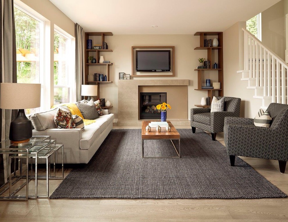 This is an example of a mid-sized transitional living room in Vancouver with beige walls, a standard fireplace and a wall-mounted tv.