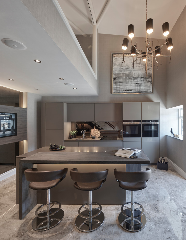 This is an example of a mid-sized contemporary separate kitchen in Other with a drop-in sink, flat-panel cabinets, brown cabinets, granite benchtops, brown splashback, mirror splashback, black appliances, porcelain floors, with island and brown floor.