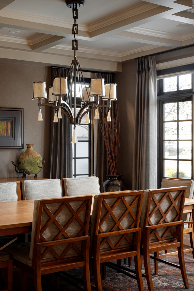 Photo of a large classic enclosed dining room in Calgary with brown walls, medium hardwood flooring, brown floors, a coffered ceiling and wallpapered walls.