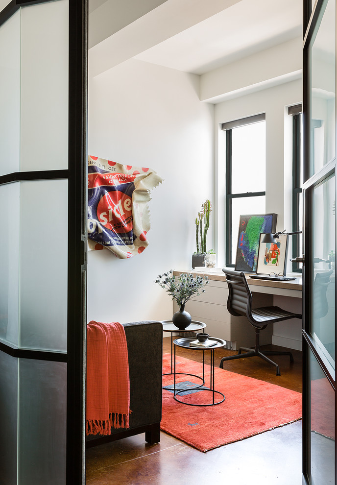 Trendy built-in desk concrete floor home office photo in Boston with white walls