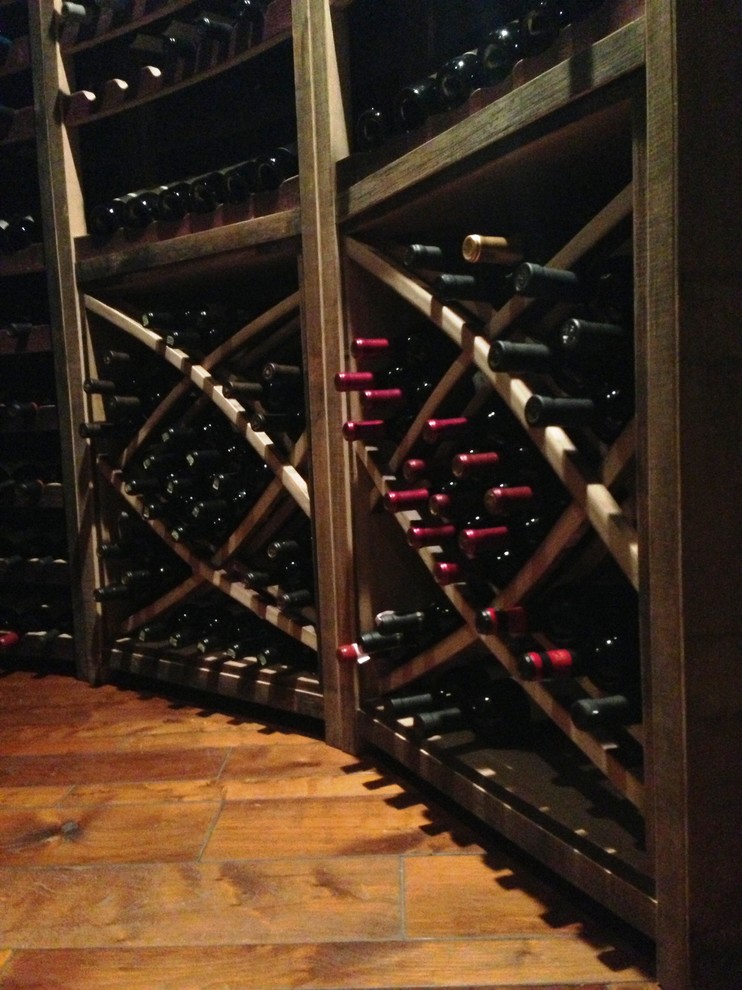 Small mediterranean wine cellar in Los Angeles with concrete floors and diamond bins.