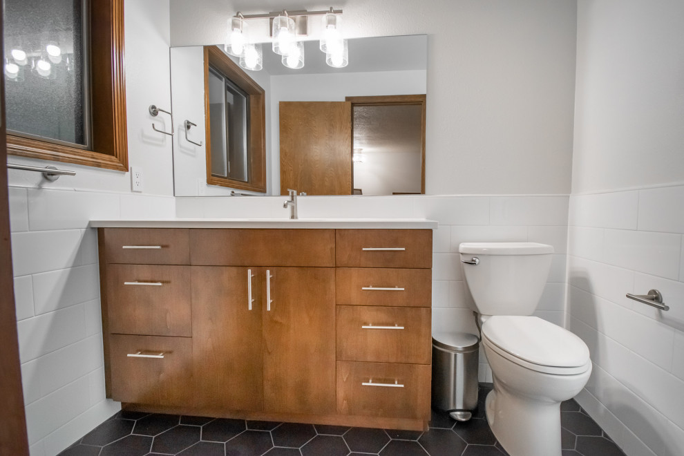 This is an example of a small modern master bathroom in Portland with flat-panel cabinets, medium wood cabinets, an alcove shower, a two-piece toilet, white tile, ceramic tile, white walls, ceramic floors, an undermount sink, engineered quartz benchtops, black floor, white benchtops, a single vanity and a built-in vanity.