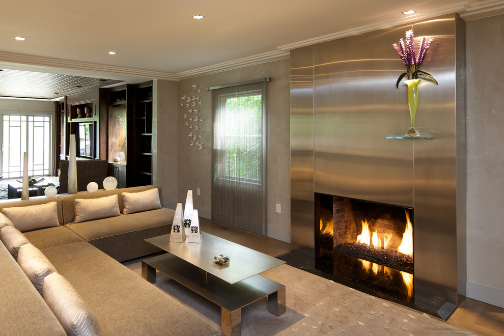 This is an example of a large contemporary open concept living room in New York with grey walls, carpet, a ribbon fireplace, a metal fireplace surround and a built-in media wall.