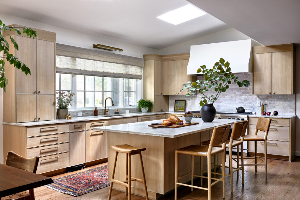 Example of a large transitional medium tone wood floor and brown floor eat-in kitchen design in DC Metro with an undermount sink, flat-panel cabinets, medium tone wood cabinets, quartzite countertops, white backsplash, stone tile backsplash, stainless steel appliances, an island and beige countertops