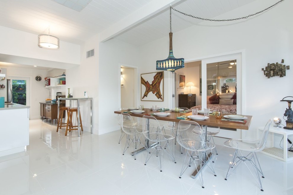 Inspiration for a contemporary kitchen/dining combo in Los Angeles with white walls and linoleum floors.