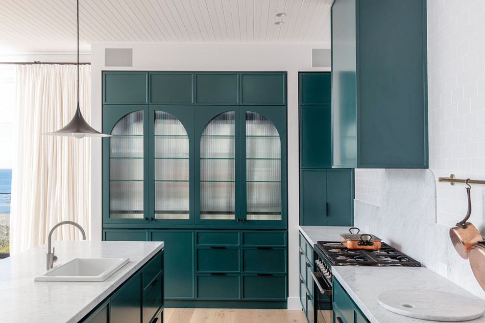 Inspiration for a large contemporary l-shaped eat-in kitchen in Sydney with a drop-in sink, shaker cabinets, blue cabinets, quartz benchtops, white splashback, subway tile splashback, stainless steel appliances, light hardwood floors, with island, brown floor and white benchtop.