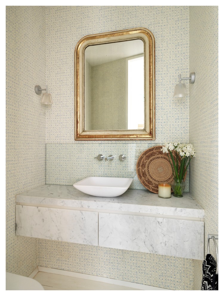 Inspiration for a small contemporary powder room in Sydney with a vessel sink, marble benchtops and beige walls.