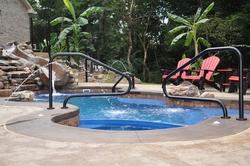 Water slide - mid-sized rustic backyard concrete and custom-shaped water slide idea in St Louis