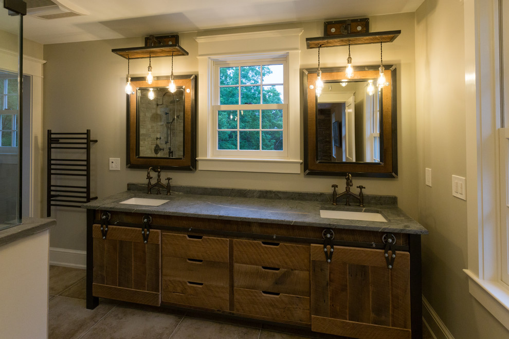 Country master bathroom in DC Metro with medium wood cabinets, an open shower, grey walls, pebble tile floors, an undermount sink, soapstone benchtops and a hinged shower door.