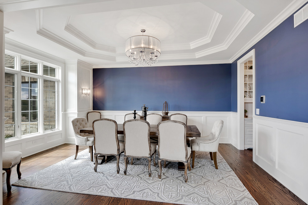 Inspiration for a traditional separate dining room in Chicago with blue walls, dark hardwood floors and brown floor.