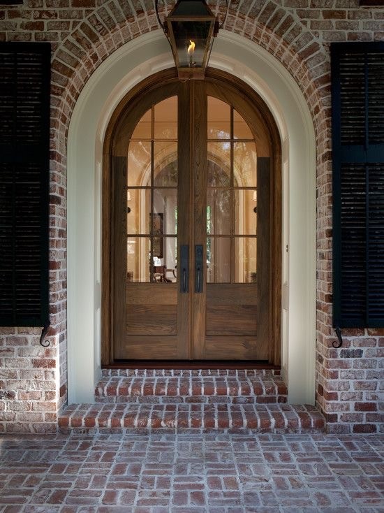 This is an example of a large transitional front door in Atlanta with a double front door and a glass front door.