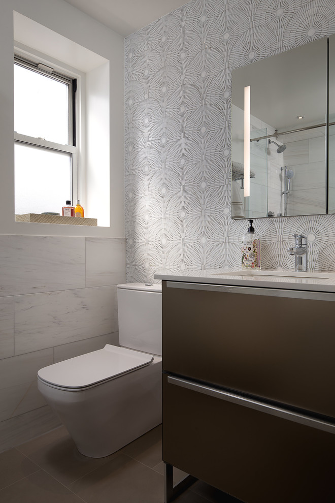 This is an example of a mid-sized contemporary master wet room bathroom in New York with flat-panel cabinets, brown cabinets, a one-piece toilet, white tile, ceramic tile, white walls, cement tiles, quartzite benchtops, beige floor and white benchtops.