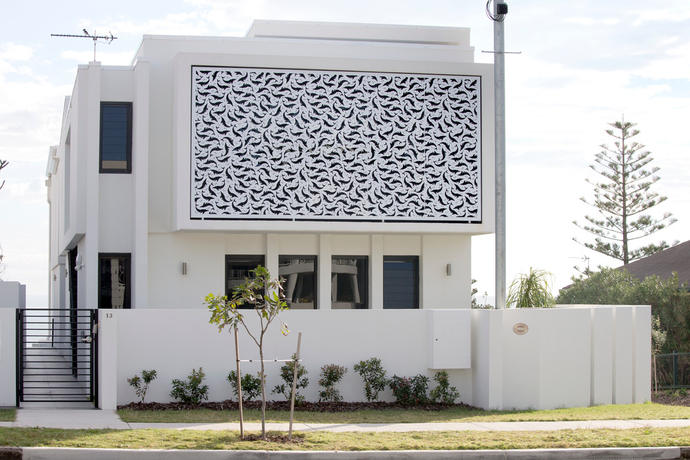 This is an example of a large beach style two-storey white exterior in Sunshine Coast.