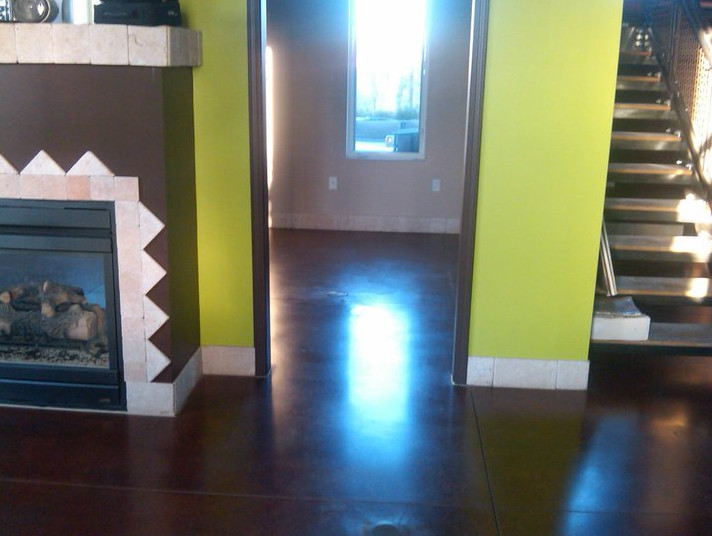 Example of a porcelain tile hallway design in Kansas City with green walls